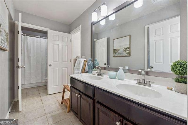 bathroom with tile patterned flooring, double vanity, and a shower with shower curtain