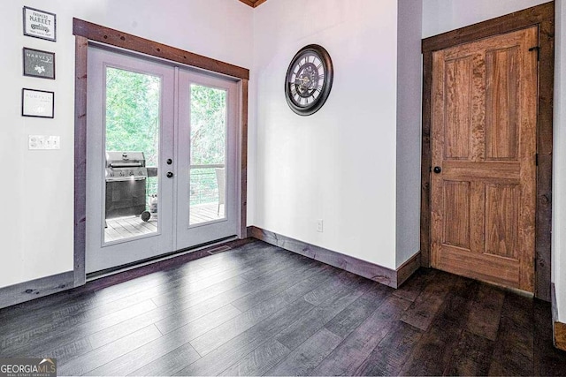 doorway featuring french doors, dark wood-style flooring, and baseboards