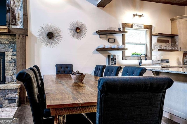 dining area with a fireplace and dark wood-type flooring