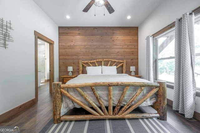bedroom with wood finished floors, recessed lighting, wood walls, baseboards, and a ceiling fan