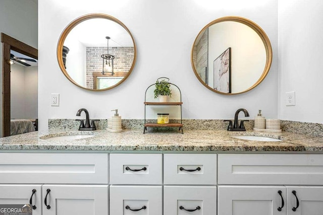 ensuite bathroom with double vanity and a ceiling fan