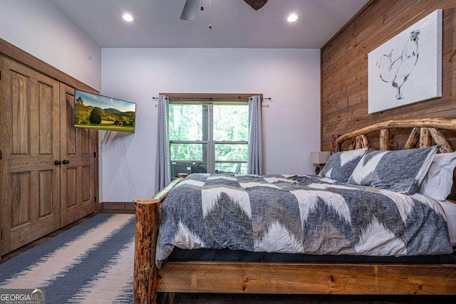 bedroom featuring wooden walls, recessed lighting, and a ceiling fan