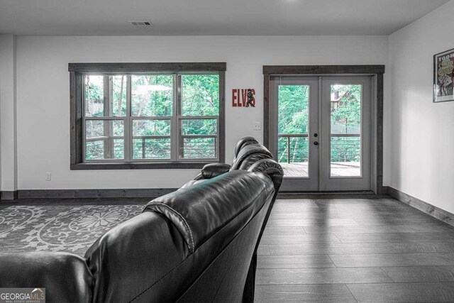 living area featuring french doors, wood finished floors, and baseboards