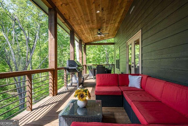 deck featuring an outdoor hangout area, a ceiling fan, a grill, and french doors
