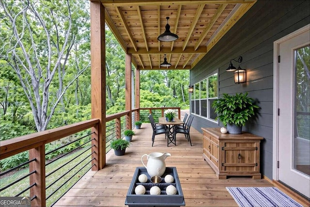 wooden terrace with outdoor dining area