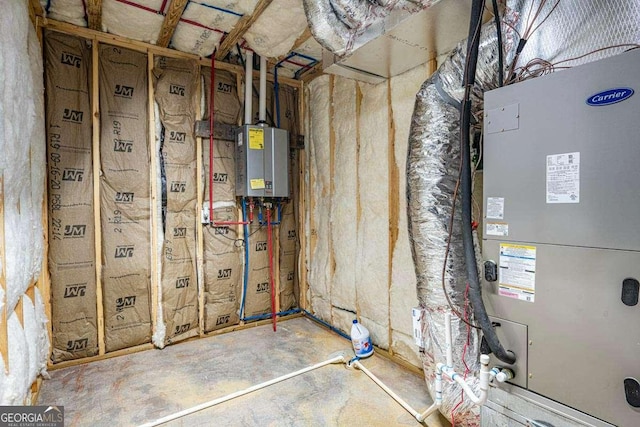 utility room featuring water heater and heating unit
