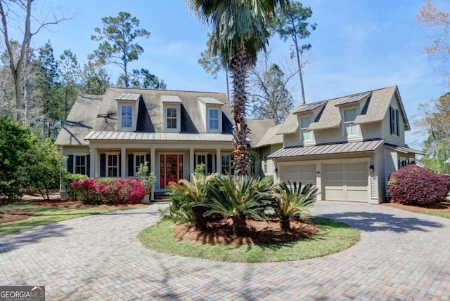 18 Enclave Cir, Savannah, GA 31419 - view of front of home with decorative driveway, covered porch, a standing seam roof, an attached garage, and a shingled roof