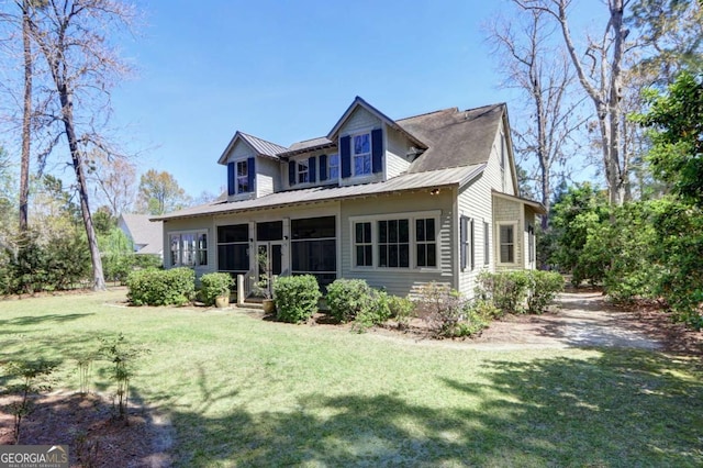 18 Enclave Cir, Savannah, GA 31419 - view of front of house featuring a front lawn, a sunroom, and metal roof