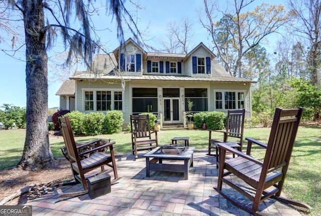 18 Enclave Cir, Savannah, GA 31419 - back of property with a fire pit, a yard, french doors, and a patio
