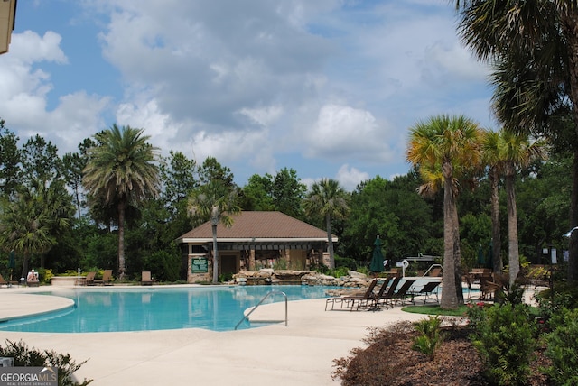 18 Enclave Cir, Savannah, GA 31419 - community pool with a patio and view of wooded area