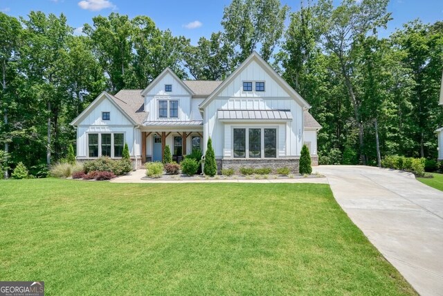 2861 Digna Ct, Acworth, GA 30101 - modern farmhouse with a standing seam roof, board and batten siding, a front yard, driveway, and a metal roof