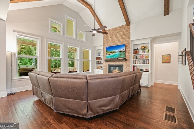 2861 Digna Ct, Acworth, GA 30101 - living area featuring a ceiling fan, a brick fireplace, dark wood-style flooring, built in shelves, and high vaulted ceiling