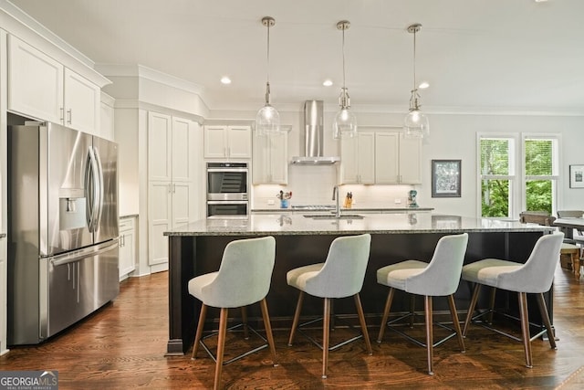 2861 Digna Ct, Acworth, GA 30101 - kitchen featuring appliances with stainless steel finishes, wall chimney range hood, ornamental molding, a kitchen island with sink, and decorative backsplash
