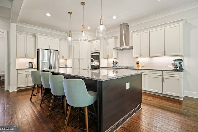 2861 Digna Ct, Acworth, GA 30101 - kitchen featuring wall chimney exhaust hood, appliances with stainless steel finishes, ornamental molding, decorative backsplash, and a kitchen breakfast bar