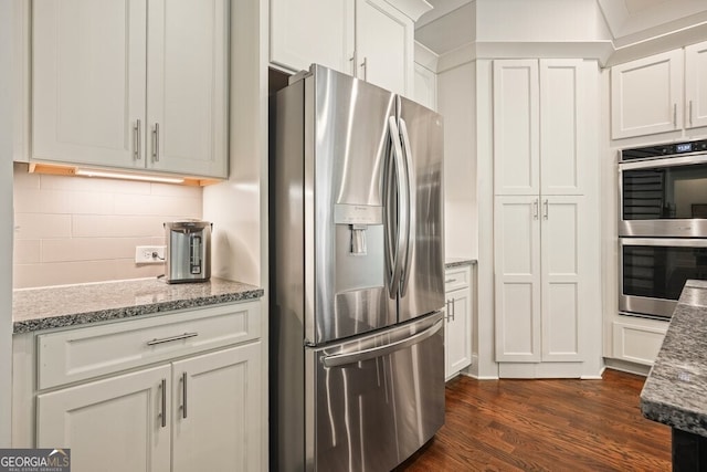 2861 Digna Ct, Acworth, GA 30101 - kitchen with stainless steel appliances, dark wood-style floors, tasteful backsplash, and white cabinets