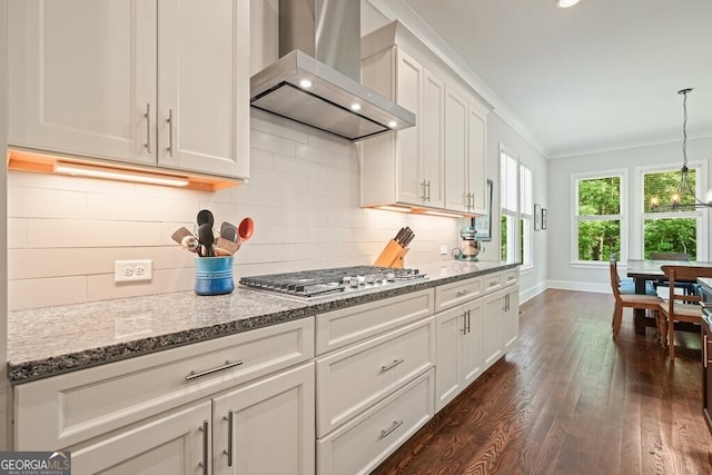 2861 Digna Ct, Acworth, GA 30101 - kitchen with wall chimney range hood, dark wood-style flooring, crown molding, backsplash, and stainless steel gas cooktop
