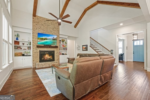 2861 Digna Ct, Acworth, GA 30101 - living room featuring high vaulted ceiling, ceiling fan, built in features, a brick fireplace, and dark wood-type flooring