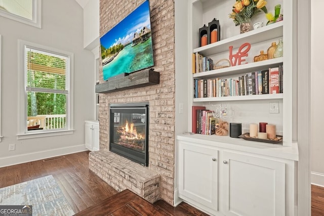 2861 Digna Ct, Acworth, GA 30101 - living area with dark wood-type flooring and a brick fireplace