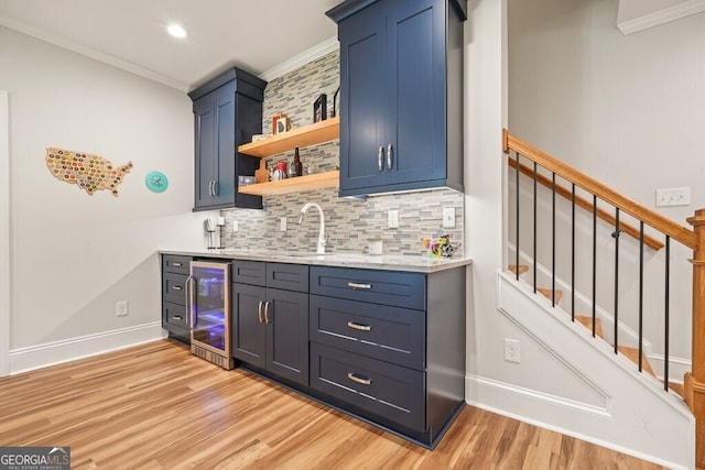 2861 Digna Ct, Acworth, GA 30101 - indoor wet bar featuring wine cooler, light wood-style floors, a wall mounted air conditioner, decorative backsplash, and ornamental molding