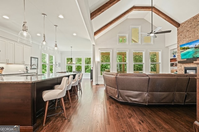 2861 Digna Ct, Acworth, GA 30101 - living room featuring ceiling fan, dark wood finished floors, high vaulted ceiling, beam ceiling, and recessed lighting