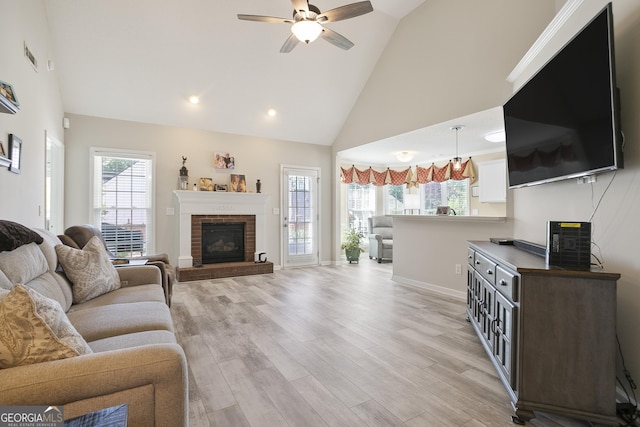 3 Bluegrass Pass, Newnan, GA 30263 - living area with a ceiling fan, high vaulted ceiling, light wood-type flooring, a fireplace, and baseboards