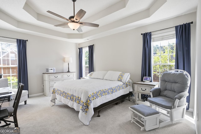 3 Bluegrass Pass, Newnan, GA 30263 - bedroom featuring a tray ceiling, light colored carpet, multiple windows, and a ceiling fan