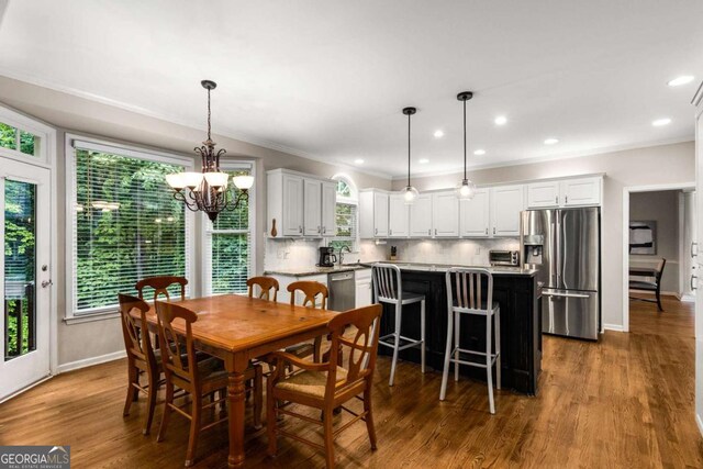 2759 Thomashire Trce, Marietta, GA 30066 - dining room featuring crown molding, a chandelier, baseboards, wood finished floors, and recessed lighting
