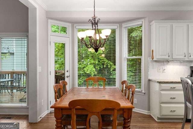 2759 Thomashire Trce, Marietta, GA 30066 - dining room with a chandelier, wood finished floors, baseboards, healthy amount of natural light, and ornamental molding