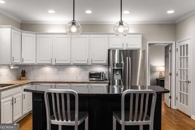 2759 Thomashire Trce, Marietta, GA 30066 - kitchen featuring stainless steel fridge, white cabinets, backsplash, a breakfast bar area, and recessed lighting