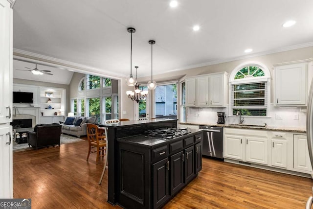 2759 Thomashire Trce, Marietta, GA 30066 - kitchen with stainless steel appliances, dark cabinets, white cabinetry, ornamental molding, and a breakfast bar