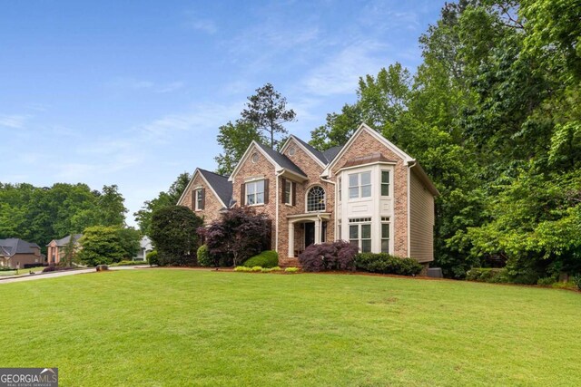 2759 Thomashire Trce, Marietta, GA 30066 - view of front of home featuring a front yard, brick siding, and central air condition unit