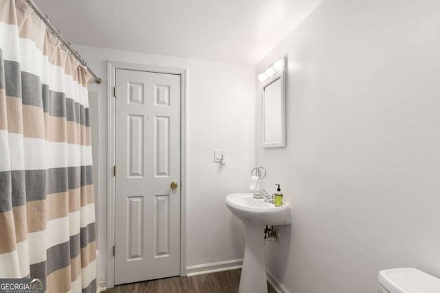 2759 Thomashire Trce, Marietta, GA 30066 - full bathroom with baseboards, wood finished floors, toilet, curtained shower, and a sink