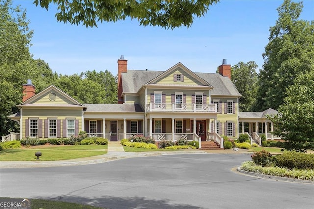 2759 Thomashire Trce, Marietta, GA 30066 - view of front of property with covered porch, a balcony, a chimney, and a front lawn