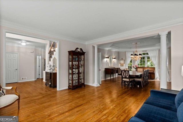 2759 Thomashire Trce, Marietta, GA 30066 - living area featuring wood finished floors, a chandelier, crown molding, and ornate columns