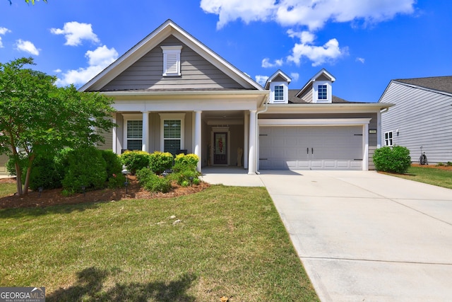 778 Firefly Ct, Griffin, GA 30223 - view of front of home featuring a garage, concrete driveway, a front yard, and covered porch