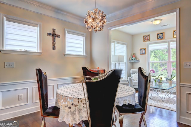 778 Firefly Ct, Griffin, GA 30223 - dining area featuring a chandelier, dark wood finished floors, a wainscoted wall, ornamental molding, and a decorative wall