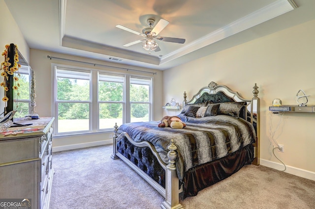 778 Firefly Ct, Griffin, GA 30223 - carpeted bedroom with a tray ceiling, baseboards, ornamental molding, and ceiling fan