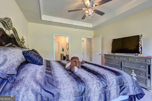 778 Firefly Ct, Griffin, GA 30223 - bedroom with a raised ceiling, connected bathroom, a ceiling fan, crown molding, and carpet floors
