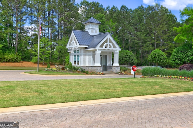 778 Firefly Ct, Griffin, GA 30223 - view of front facade featuring stone siding, a front yard, metal roof, and a standing seam roof