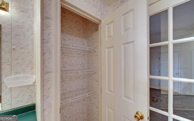bathroom with wallpapered walls