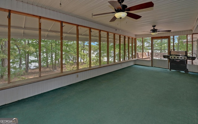 unfurnished sunroom with a ceiling fan