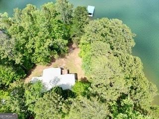 view from above of property with a heavily wooded area