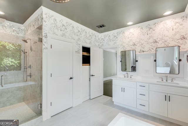 bathroom with a shower stall, double vanity, tile patterned flooring, wallpapered walls, and recessed lighting