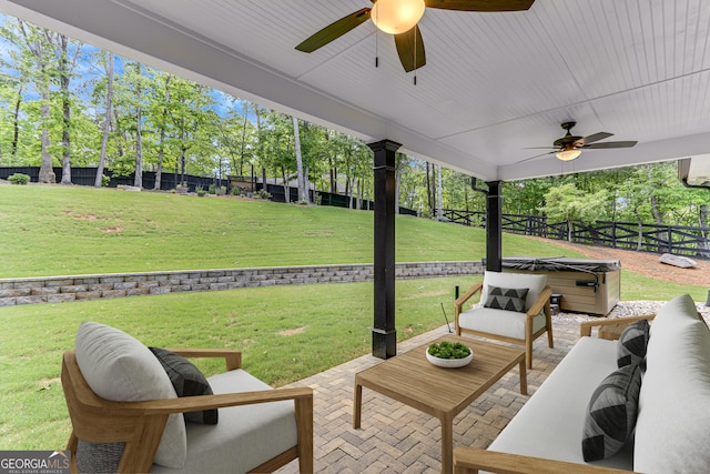 view of patio / terrace with a hot tub, ceiling fan, and an outdoor living space