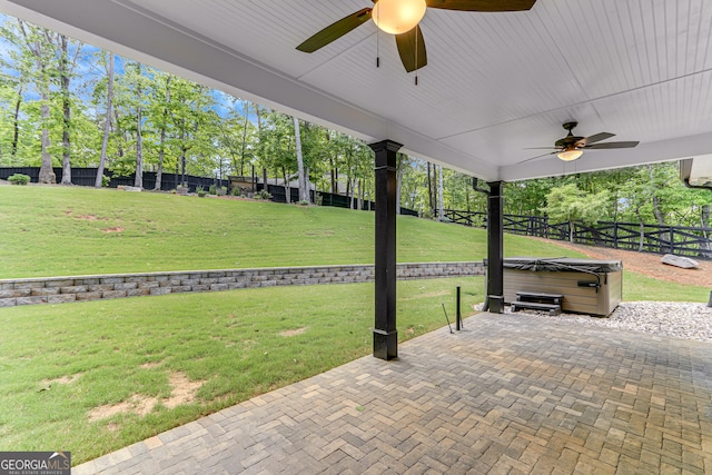 view of patio / terrace with a hot tub and a ceiling fan