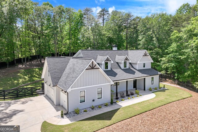 6011 Tradewinds Cv, Gainesville, GA 30506 - modern inspired farmhouse featuring board and batten siding, a shingled roof, concrete driveway, a garage, and a porch