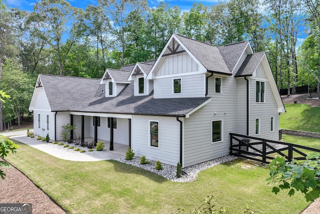 view of front of property featuring board and batten siding, roof with shingles, and a porch