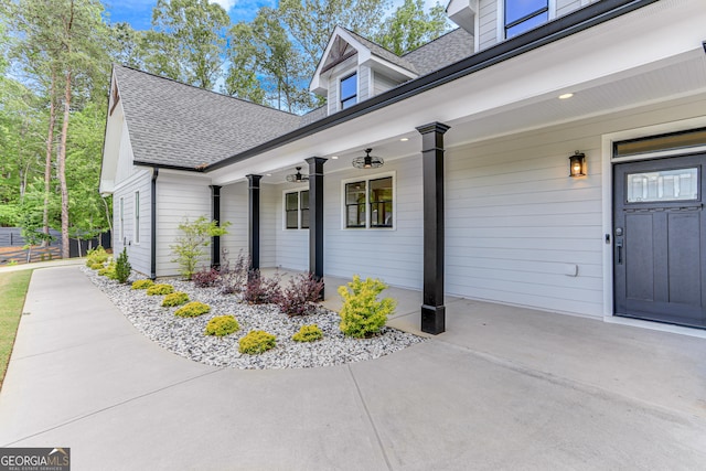 property entrance featuring a shingled roof and a porch