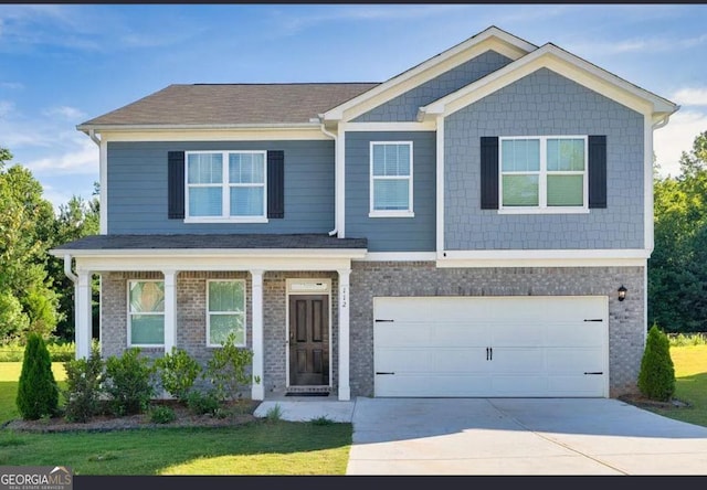 craftsman-style house with concrete driveway, a garage, brick siding, and a front lawn