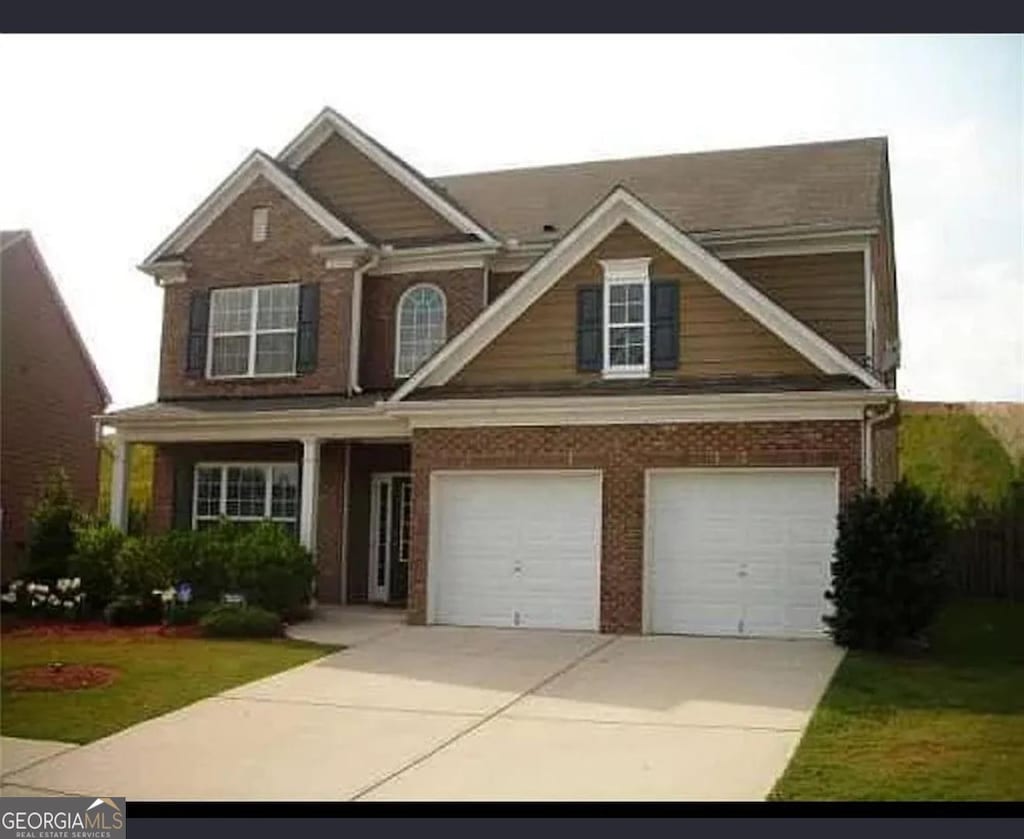 1710 Rutland Pass Dr, Lawrenceville, GA 30045 - view of front facade featuring a garage, concrete driveway, and brick siding